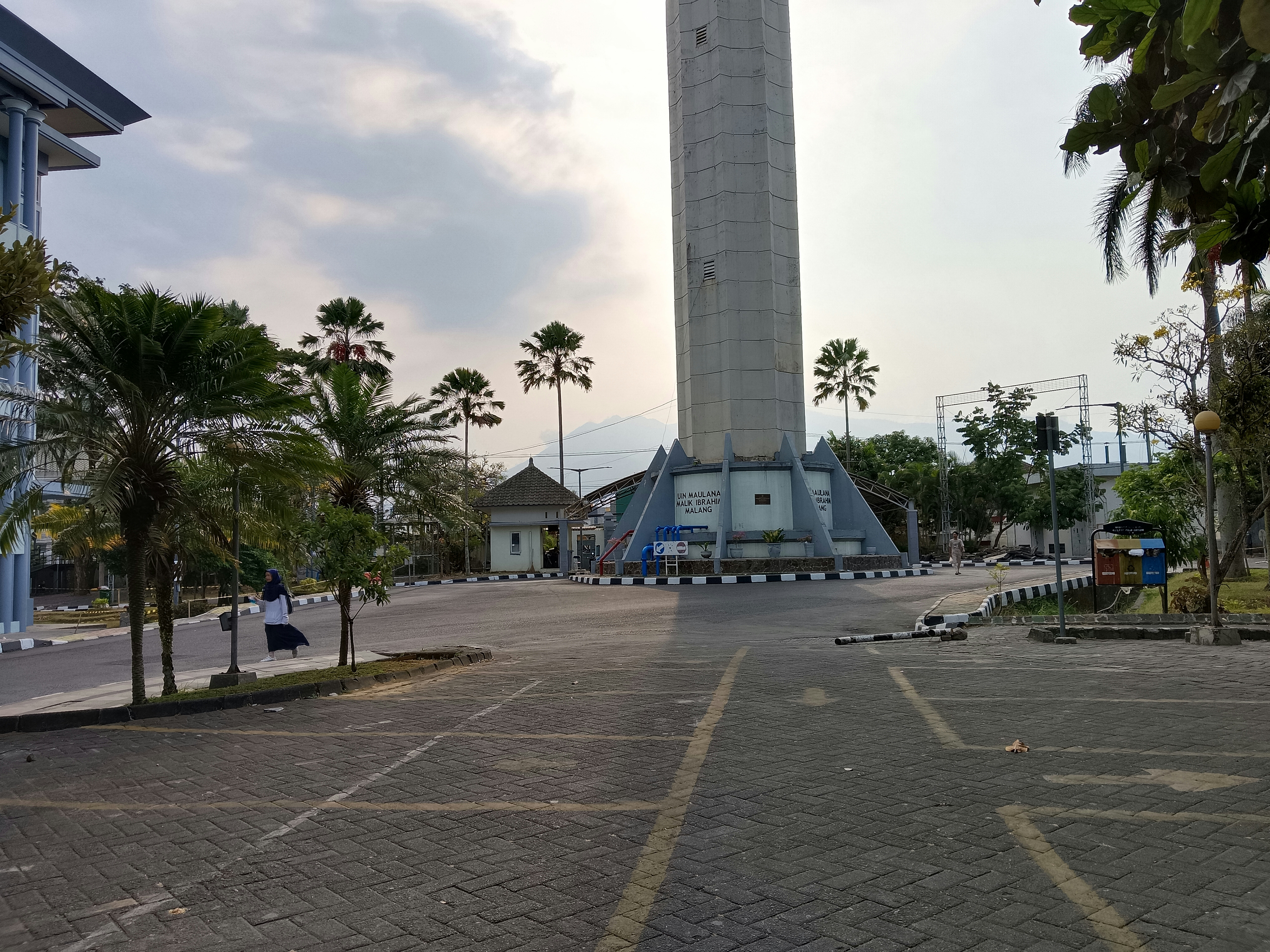 a clock tower in the middle of a parking lot
